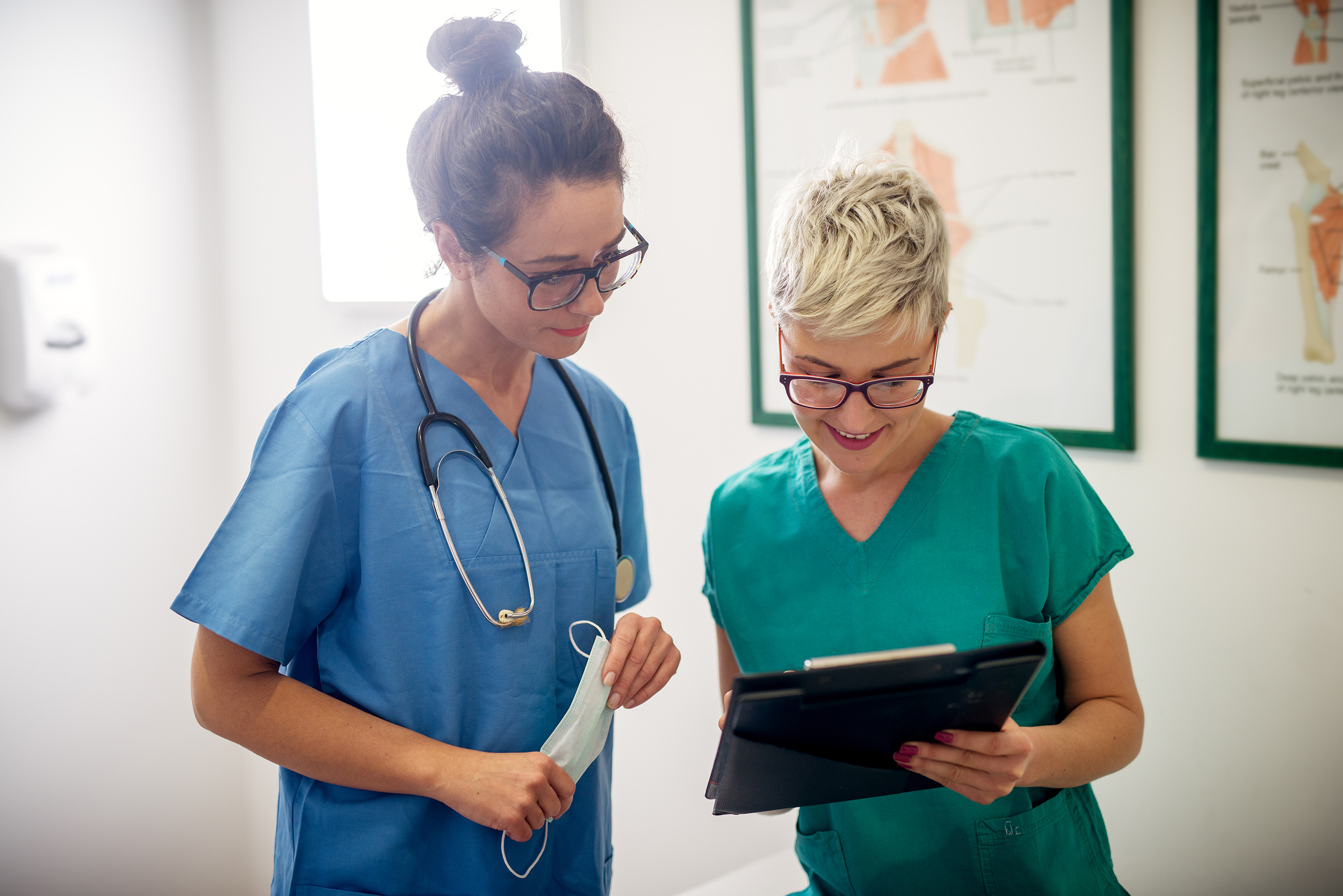 nurses discuss patient chart